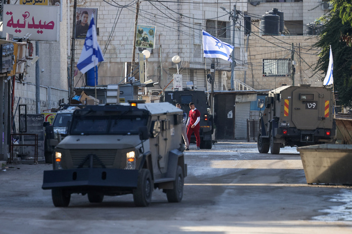 Israeli forces in armoured vehicles conduct a raid in Jenin in the occupied West Bank on January 21, 2025. (Photo by JAAFAR ASHTIYEH / AFP)