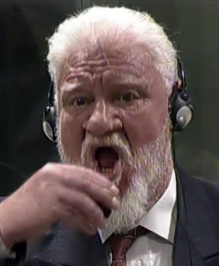 In this photo provided by the ICTY on Wednesday  Nov  29  2017  Slobodan Praljak brings a bottle to his lips  during a Yugoslav War Crimes Tribunal in The Hague  Netherlands  Praljak yelled   I am not a war criminal   and appeared to drink from a small bottle  seconds after judges reconfirmed his 20-year prison sentence for involvement in a campaign to drive Muslims out of a would-be Bosnian Croat ministate in Bosnia in the early 1990s   ICTY via AP