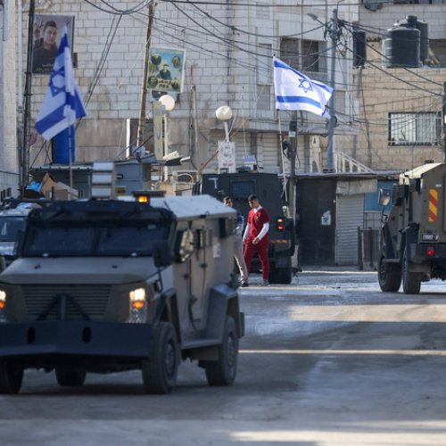 Israeli forces in armoured vehicles conduct a raid in Jenin in the occupied West Bank on January 21, 2025. (Photo by JAAFAR ASHTIYEH / AFP)