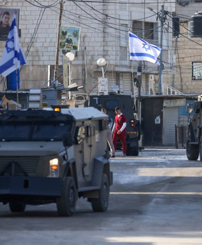 Israeli forces in armoured vehicles conduct a raid in Jenin in the occupied West Bank on January 21, 2025. (Photo by JAAFAR ASHTIYEH / AFP)
